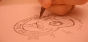 Hand drawing a logo on paper