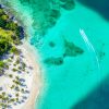 Aerial drone view of beautiful caribbean tropical island Cayo Levantado beach with palms and boat. Bacardi Island, Dominican Republic. Vacation background.